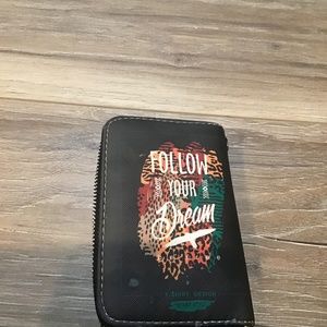 A small wallet that says follow your dream